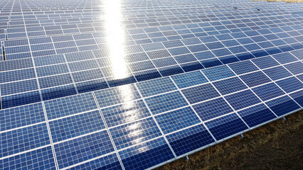 Aerial drone view flight over solar panels on sunny day close-up. Photovoltaic solar panel. Moving...