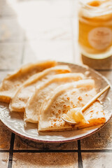 Ghee butter in glass jar and pancakes on table. Healthy eating, breakfast