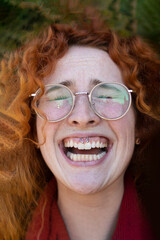 Portrait of a redhair woman laughing hysterically