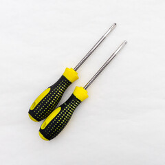 Tool for tightening screws and self-tapping screws. Screwdrivers with black and yellow handle.