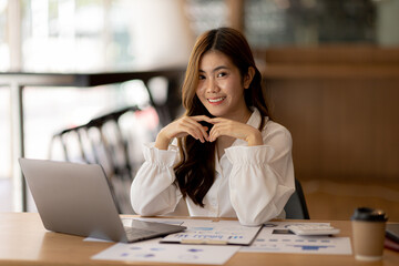Beautiful Asian woman is a businesswoman who leads a new generation of startups, a woman who runs and manages a business plan to build confidence and stability in business, woman-led business concept.