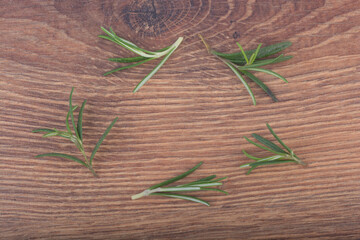 sprig of rosemary on wooden background