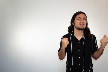portrait of a very angry, furious and upset hispanic man on a white background