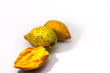 a group of ripe yellow egg fruit or canistel (commonly known as the cupcake fruit, Pouteria campechiana, Sawo mentega, sawo ubi, sawo belanda, alkesah) isolated on white background.