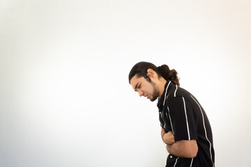 young hispanic man with stomach ache on a white background