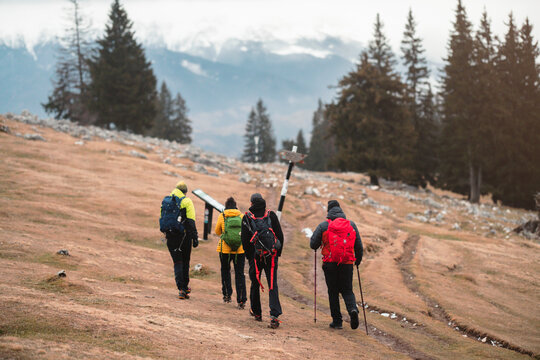 Carefree young trekkers in the winter vacation hiking uphill on a picturesque mountain. Tourist couple exploring the stunning Carpathians for fun recreation