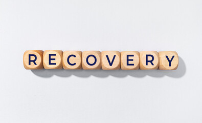 Recovery word on wooden blocks isolated on gray background