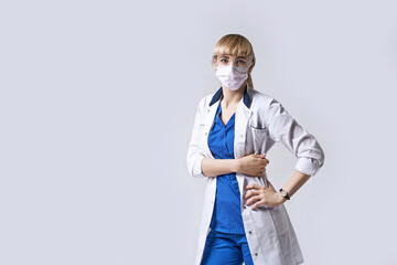 Confident female doctor wearing protective face mask. Portrait on light grey background.