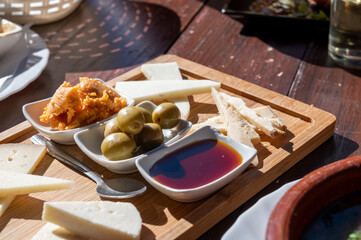 Dinner at guachinche, typical Canary Island establishment on Tenerife, where locally produced white or red wine served accompanied by homemade traditional food, tapas and goat cheese