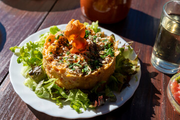 Dinner at guachinche, typical Canary Island establishment on Tenerife, where locally produced white or red wine served accompanied by homemade traditional food, sweet potato salad