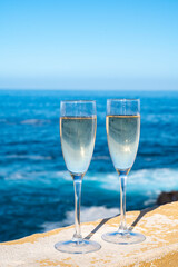 New year celebration with two glasses of champagne or Spanish cava sparkling wine and view on blue Atlantic ocean, Canary islands, winter tourists destination