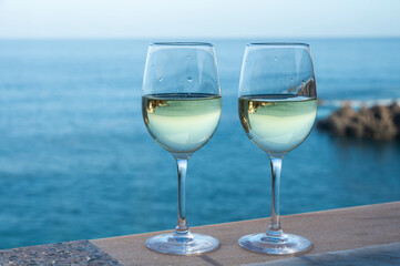 Drinking of white wine with view on blue Atlantic ocean on Tenerife, Canary islands, Spain