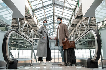 Young couple near escalators in airport