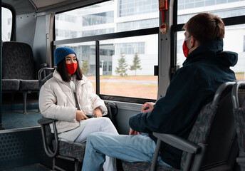 Diverse man and woman sitting near bus window