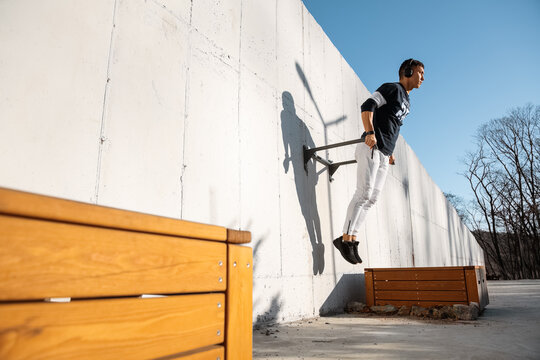 Sportsman exercising on wall on street