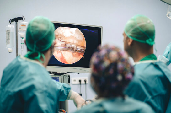 Surgeons viewing monitor during operation
