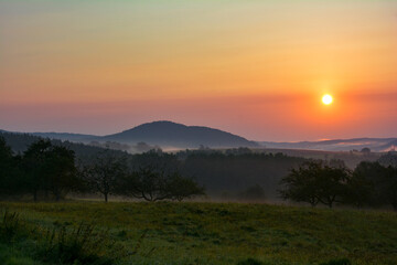 Morning mood at sunrise, hilly nature  with fog