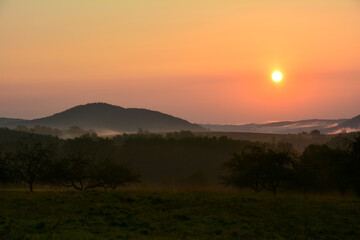 Morning mood at sunrise, hilly landscape with fog