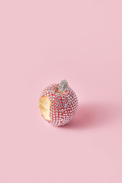 Bitten apple with shiny gemstones
