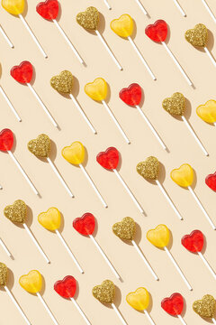 Pattern of colored heart shaped lollipops