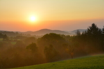 Morning fog at sun rises over a landscape
