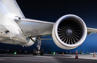 airliner wing equipped with a powerful engine at night  - obrazy, fototapety, plakaty