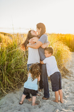 Same-sex parents with children at beach