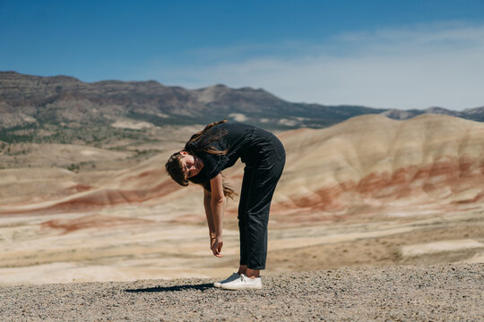 Person in Jumpsuit Bending Forward