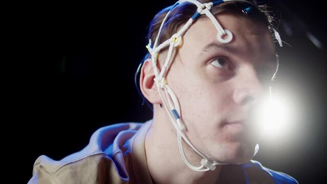 EEG topographer for examining brain, making electrogram of scalp activity. Researching of brain work, sportsman riding bicycle in electroencephalography headset. Rehabilitation after damage in sport.