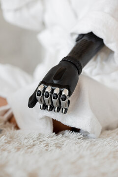 Girl with a prosthesis on her arm. Close-up photo