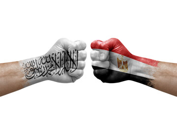 Two hands punch to each others on white background. Country flags painted fists, conflict crisis concept between afghanistan and egypt