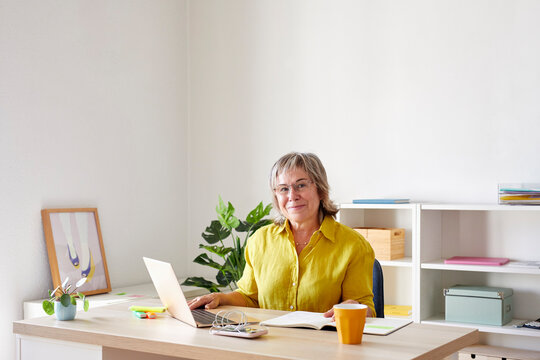 Positive businesswoman working in office