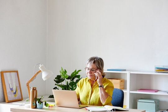 Woman answering phone call at workplace