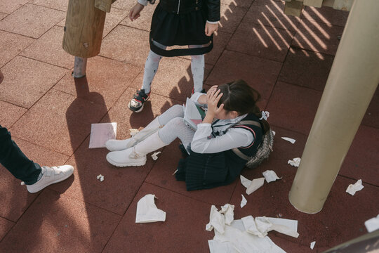 Children abuse the girl. The girl is crying .