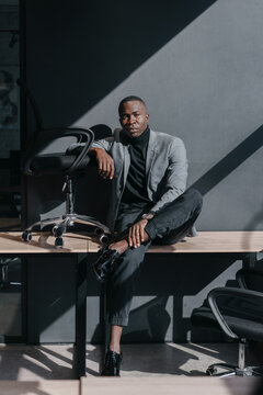 A black man in a gray business suit in the office