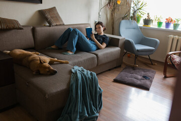 girl reading a book on the couch
