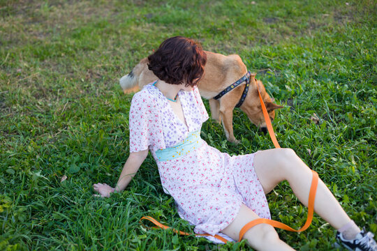 girl in the grass with a dog
