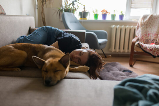 girl and dog sleeping on the couch
