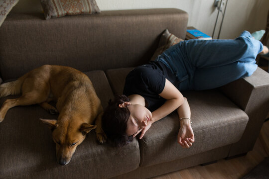 girl sleeping with a dog on the couch
