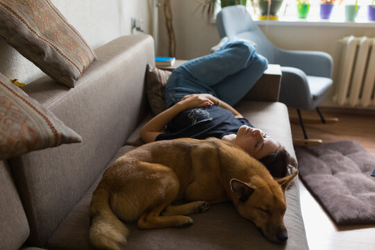 girl sleeping with a dog on the couch
