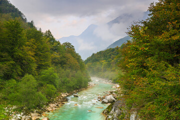 Naklejka na ściany i meble Swing Bridge across River Soča, foggy autumn valley near Kobarid, Slovenia