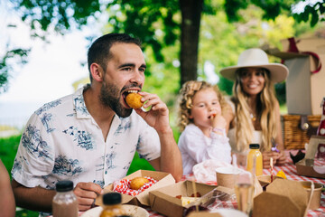 Happy young family having picnic