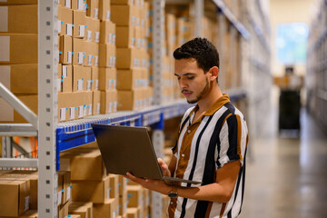 Warehouse Manager alone with  laptop computer 