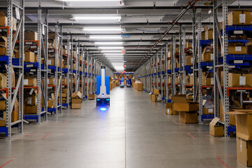 Single robot glides through clean Ecommerce  Warehouse 