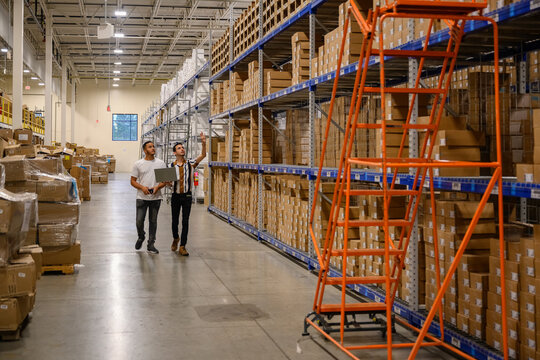 Trainee meeting with laptop computer at warehouse