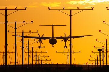 Propeller aircraft arriving after a flight during sunset