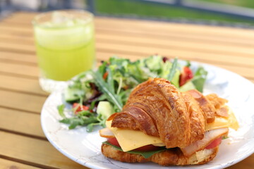Fragrant croissant with beef bacon, spinach, avocado, poached egg and hollandaise sauce!