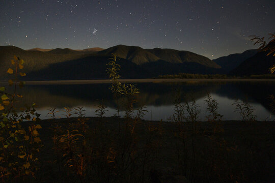 Calm lake and mountains at night