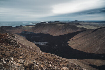 Valley filled with black lava after eruption.