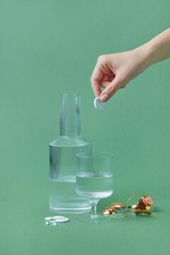 Glass of water with pill for recovering from hangover